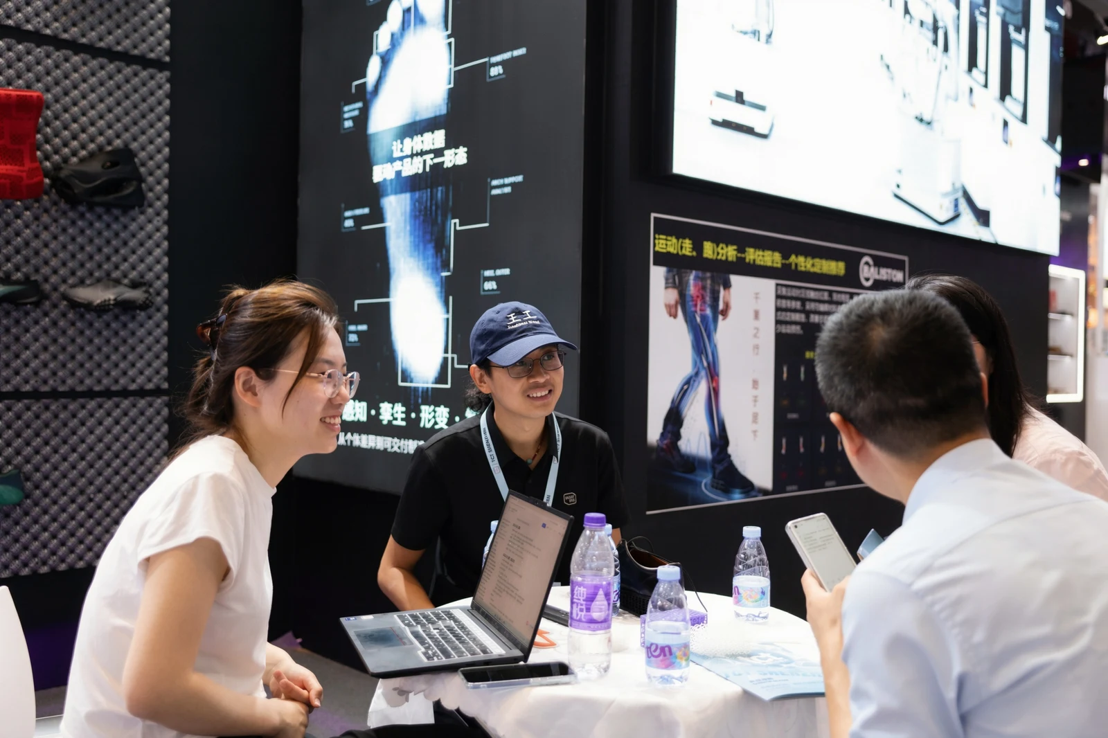 PollyPolymer team speaking with visitors at an exhibition